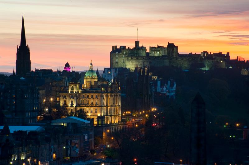 Floodlit at night, edinburgh castle, the camera obscura (pink) and other landmarks in the so called Athens of the north