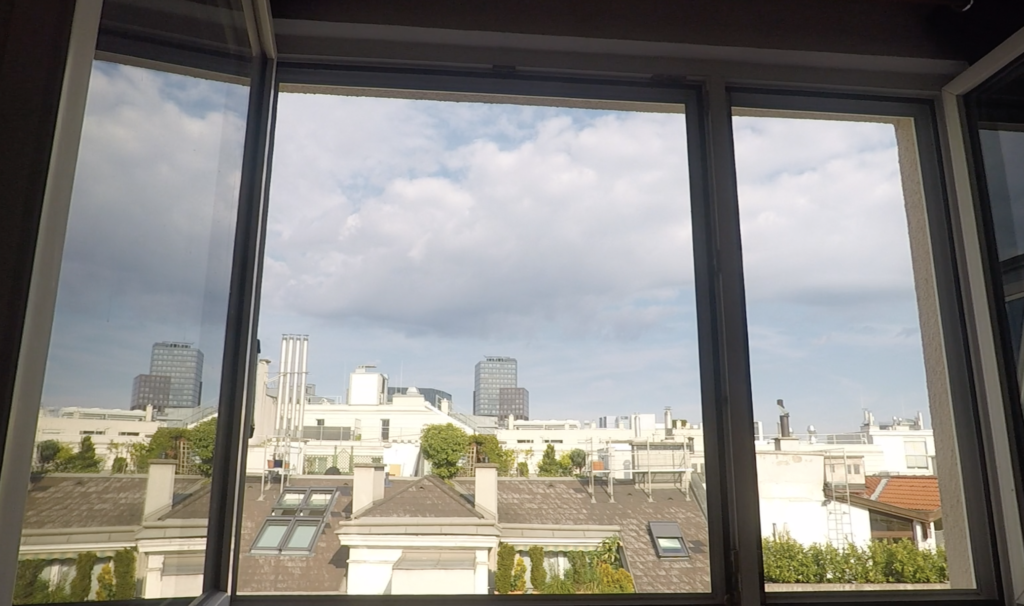 Window looking onto sunny city
