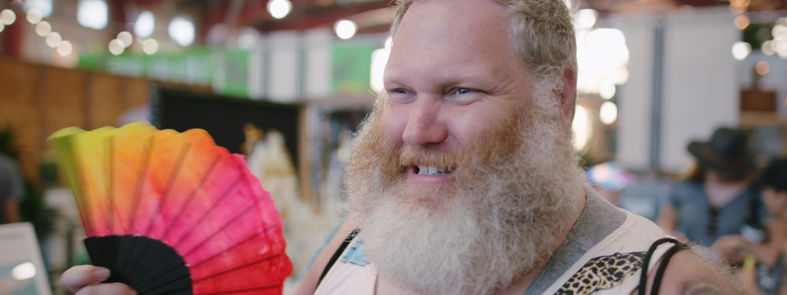 Man with rainbow flag and great big beard